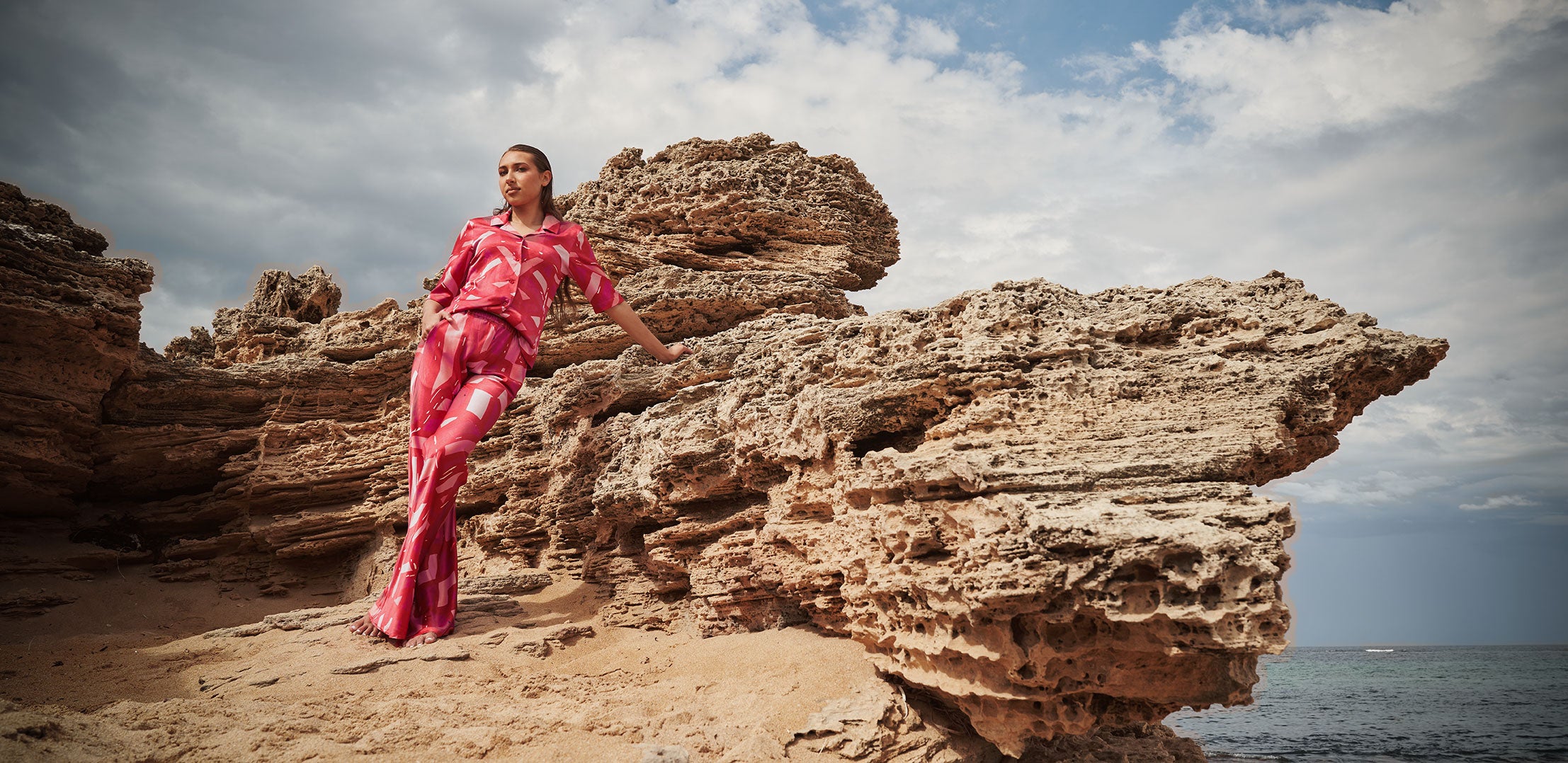 Kahleah Garlet Wearing  Clair Helen Pink two piece Pant and top outfit on beach 